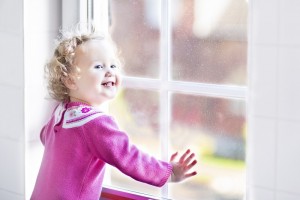 little girl enjoying replacement window during the holiday season